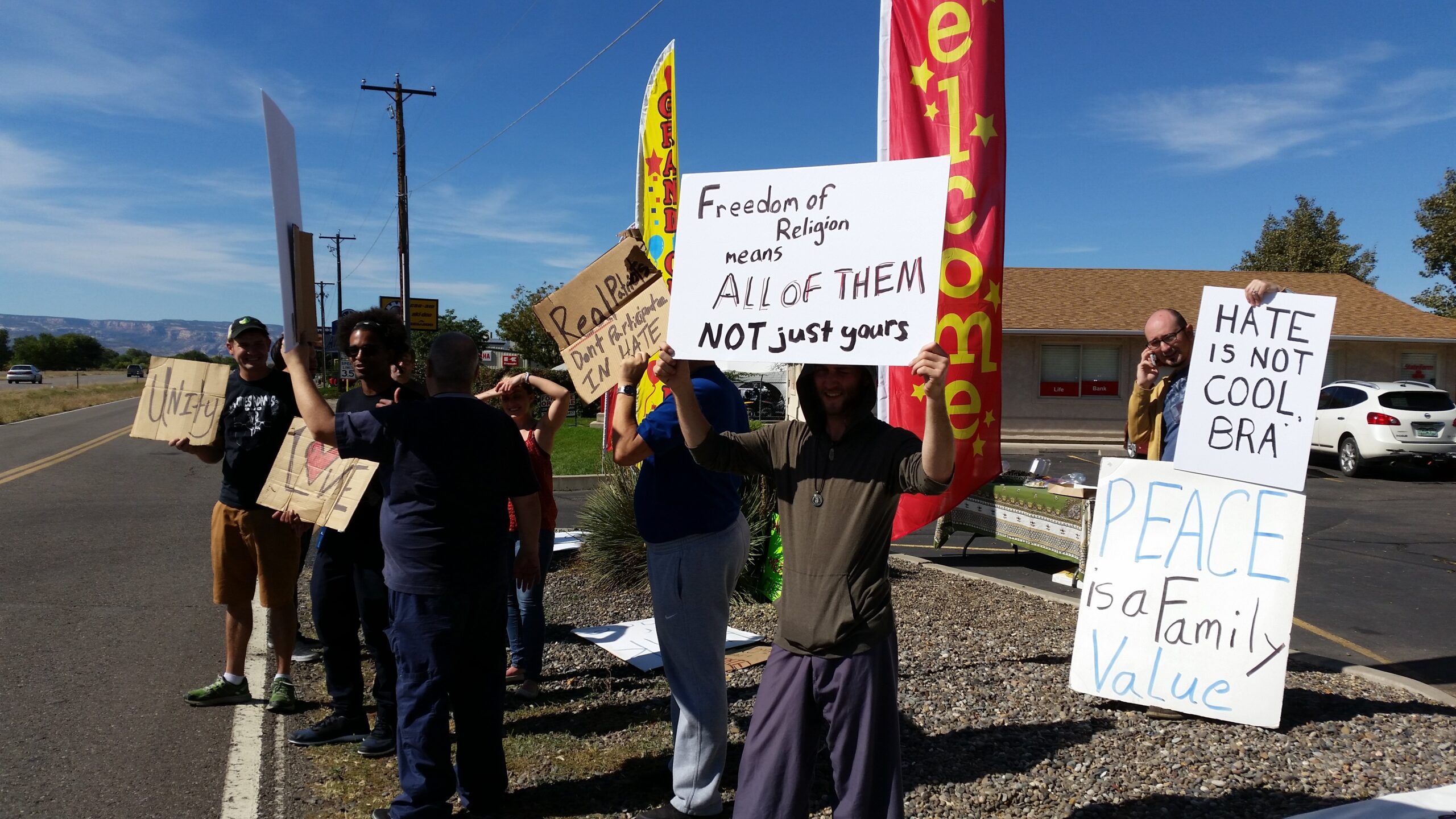 Anti-Islamaphobia rally participants hold signs in Grand Junction