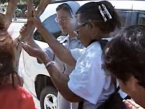 Fresno parishioners worship beneath an aphid-infested tree in front of their church (Photo credit: WPTV)