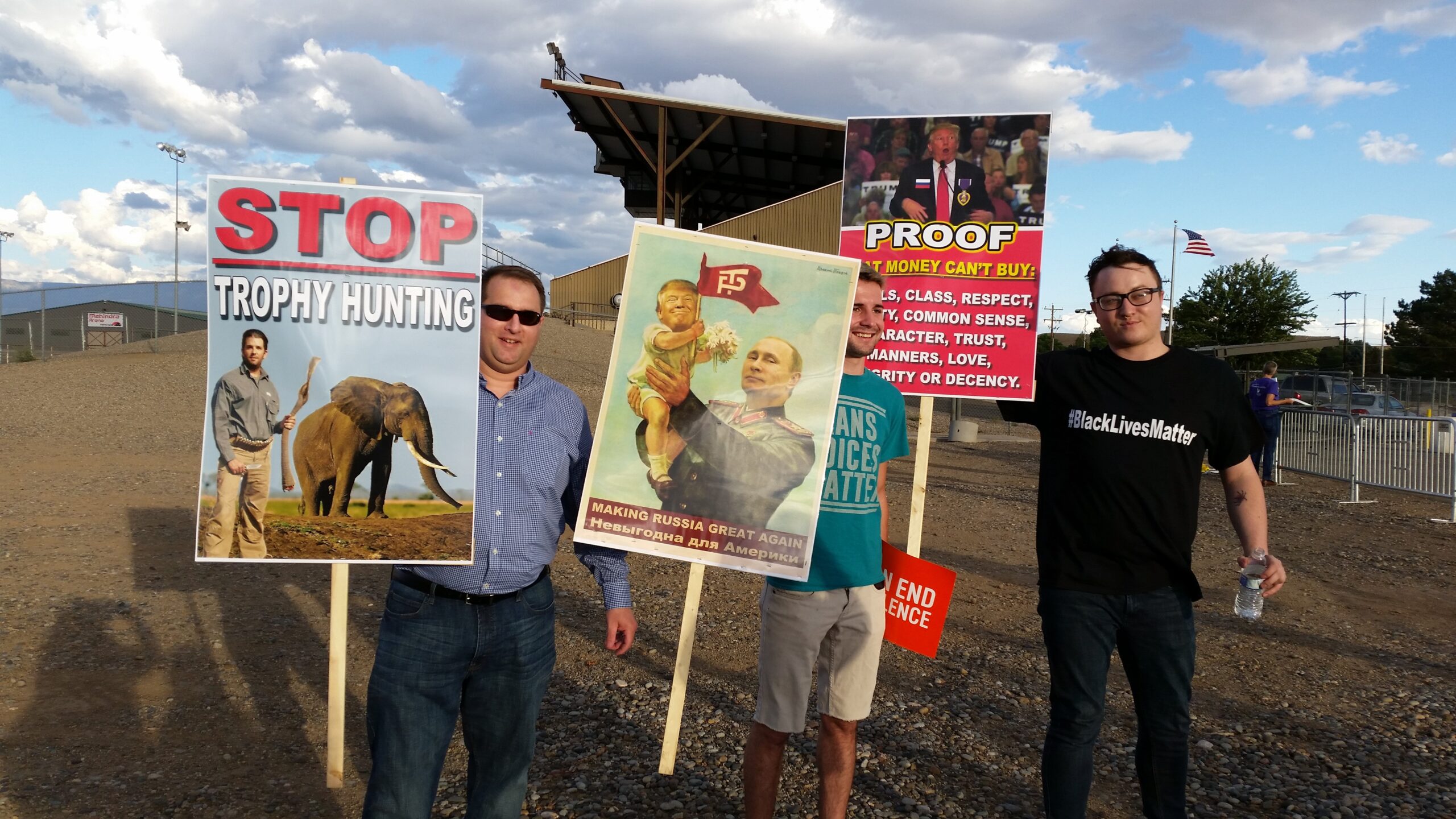 Protesters hold signs outside the TrumpJ unior rally