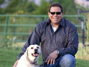 A grinning Rep. Scott poses with a well-fed dog, while hundreds of kids go hungry in Mesa County every week